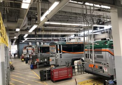 Garage with busses and overhead LED lighting