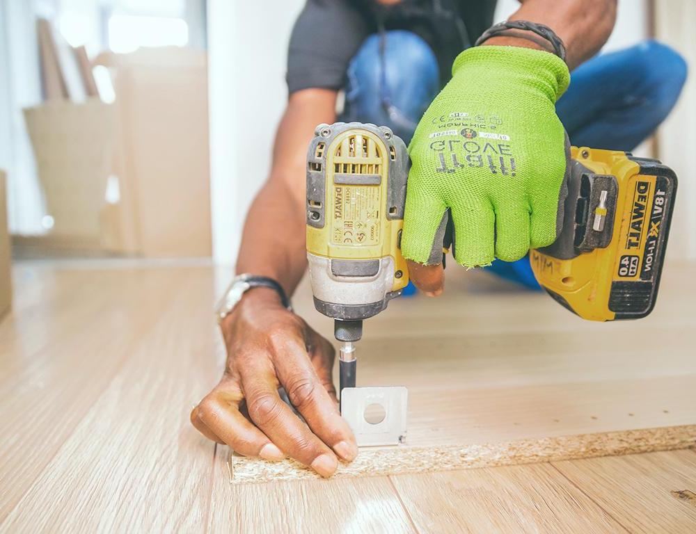 man drilling wood 