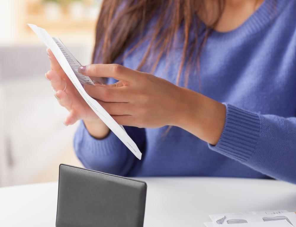 woman filling envelope