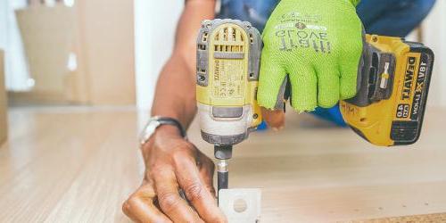 man drilling wood 